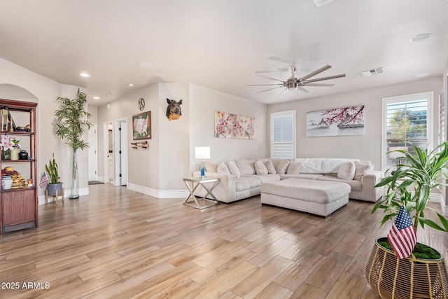 living room featuring ceiling fan and light wood-type flooring