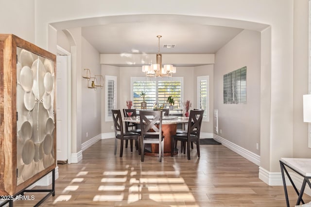 dining room featuring an inviting chandelier and wood-type flooring