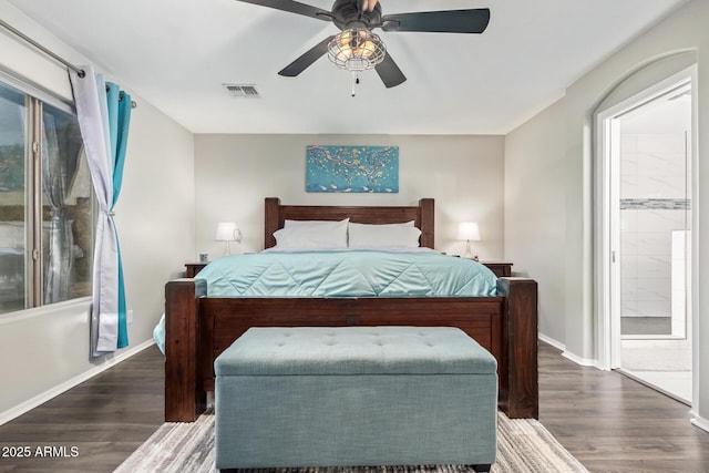 bedroom featuring ensuite bath, ceiling fan, and dark hardwood / wood-style floors