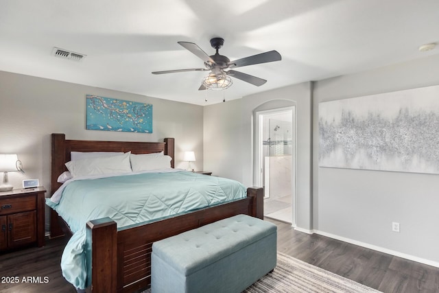 bedroom featuring ceiling fan, dark wood-type flooring, and ensuite bathroom