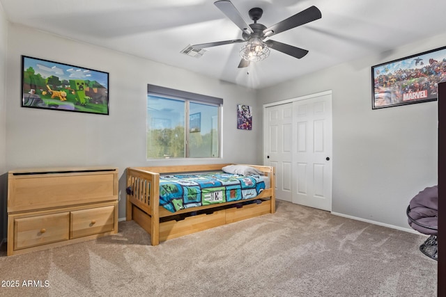 bedroom featuring ceiling fan, a closet, and carpet floors