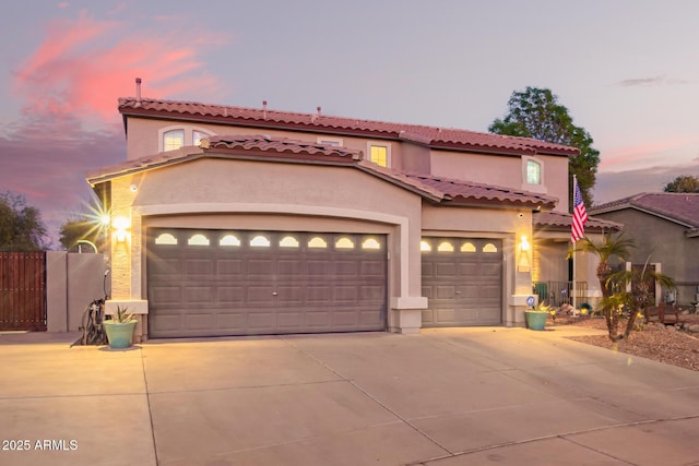 mediterranean / spanish home featuring a garage