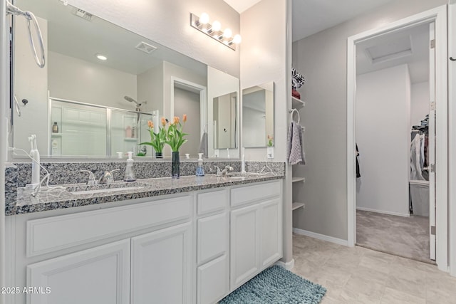 996 W Shannons Way, Coolidge, AZ 85128 - full bath featuring double vanity, a stall shower, a walk in closet, and baseboards