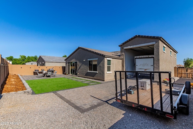 996 W Shannons Way, Coolidge, AZ 85128 - back of property with a fenced backyard, stucco siding, and a patio area