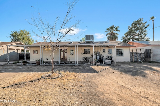 rear view of property featuring central AC