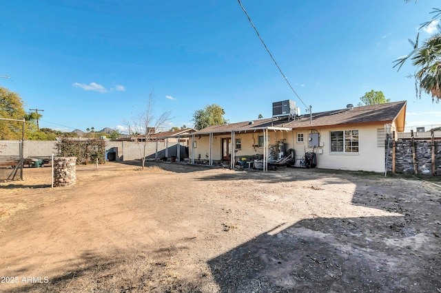 rear view of house with central AC unit