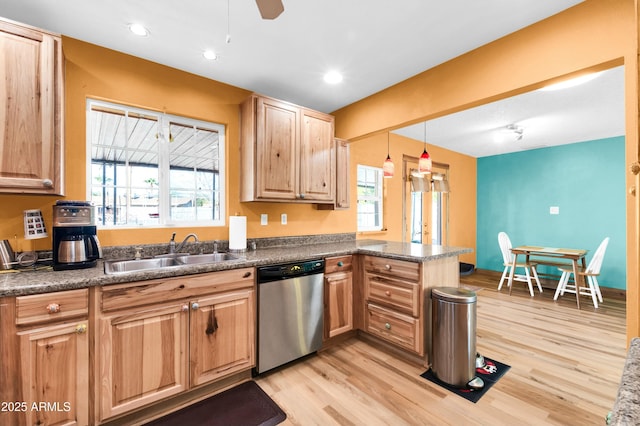 kitchen featuring sink, hanging light fixtures, light wood-type flooring, kitchen peninsula, and dishwasher