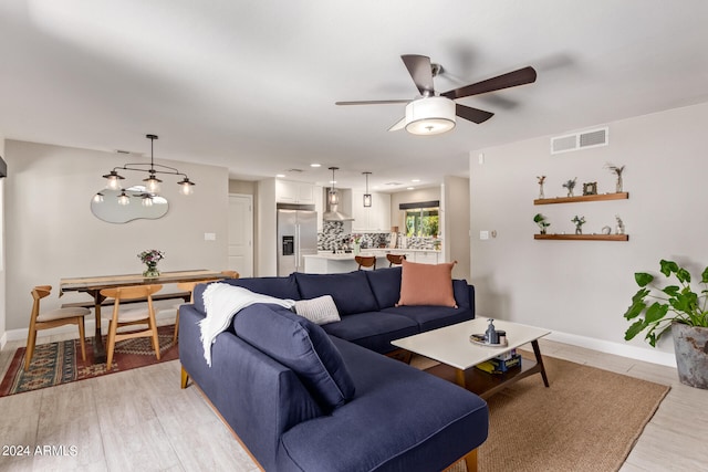 living room with ceiling fan and light hardwood / wood-style floors