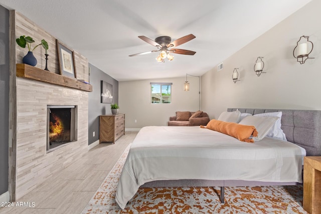 2520 E Flower St, Phoenix, AZ 85016 - bedroom featuring light hardwood / wood-style floors, ceiling fan, and a fireplace