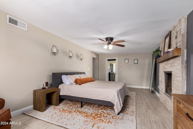 2520 E Flower St, Phoenix, AZ 85016 - bedroom featuring a fireplace, ceiling fan, and light hardwood / wood-style flooring