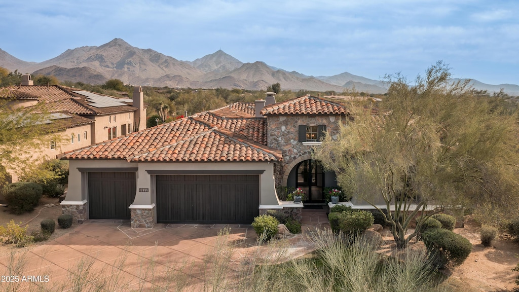 mediterranean / spanish home featuring a mountain view and a garage