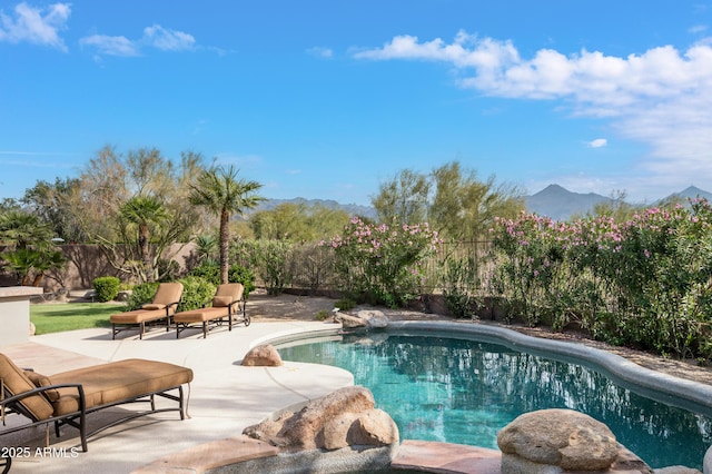 view of pool featuring a mountain view and a patio