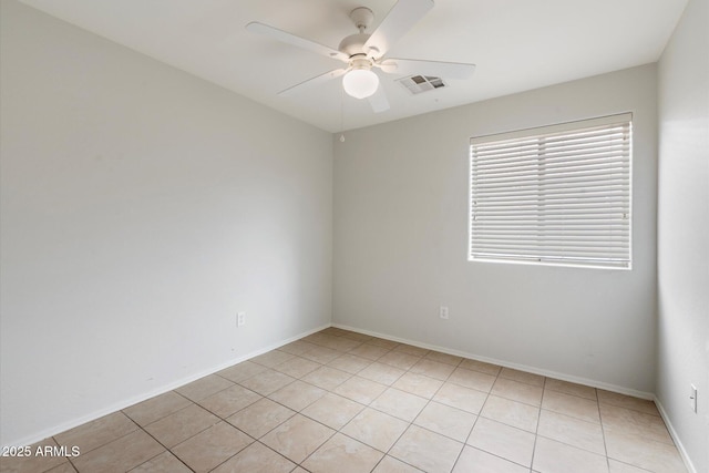 tiled empty room featuring ceiling fan