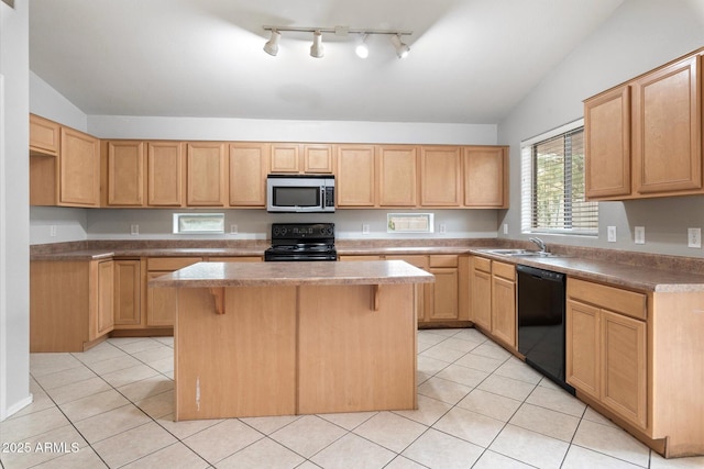 kitchen with a kitchen breakfast bar, black appliances, a center island, and light brown cabinets