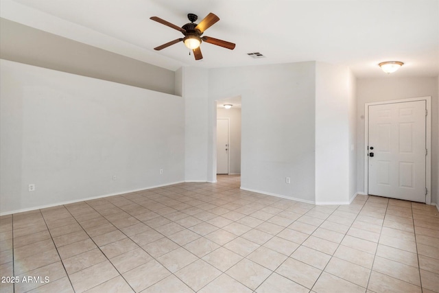 unfurnished room with vaulted ceiling, light tile patterned flooring, and ceiling fan