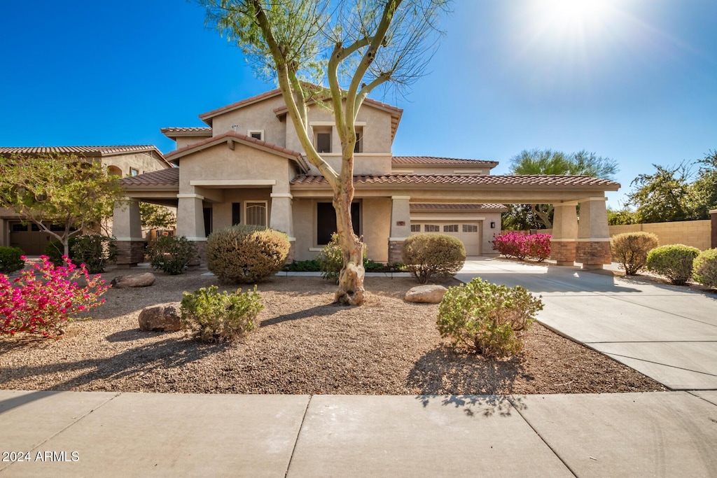 mediterranean / spanish-style home with a garage