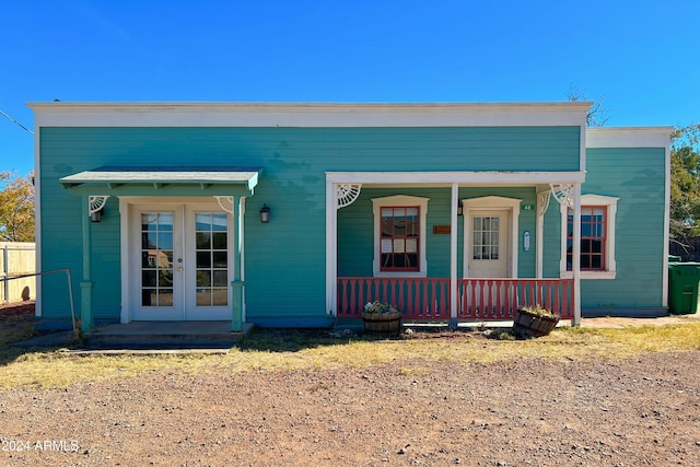 view of front of home with french doors and covered porch