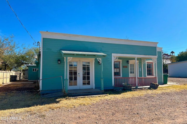 view of front of home with french doors and a porch