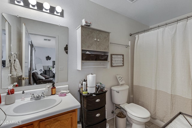 bathroom with vanity, walk in shower, and toilet