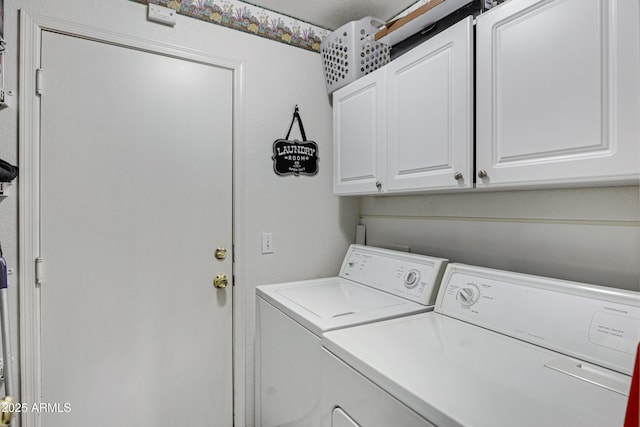 laundry room featuring cabinets and separate washer and dryer