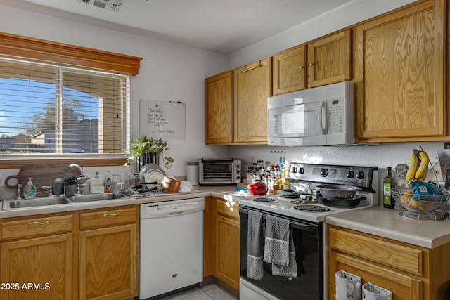 kitchen featuring sink and white appliances