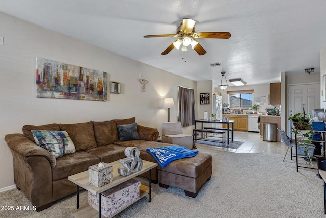 carpeted living room featuring ceiling fan