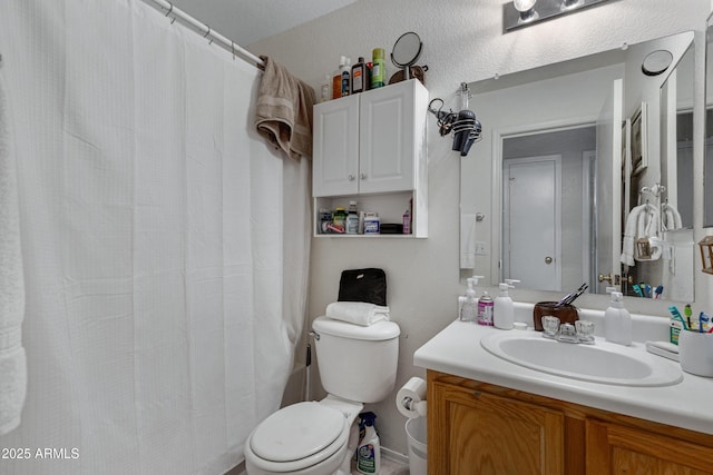 bathroom with vanity, curtained shower, and toilet