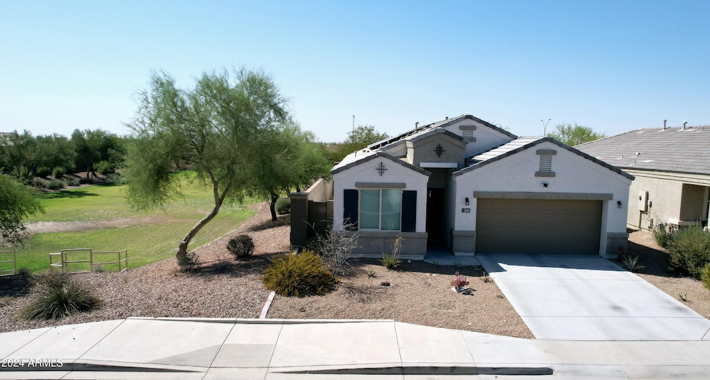 view of front of house with a front yard and a garage