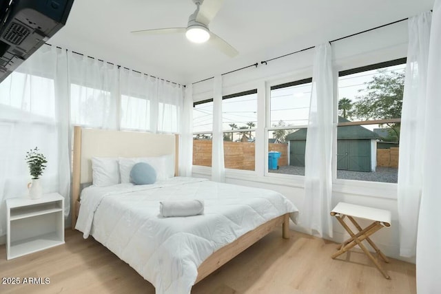 bedroom featuring multiple windows and hardwood / wood-style flooring