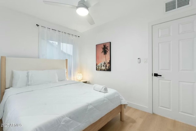 bedroom featuring light hardwood / wood-style flooring and ceiling fan