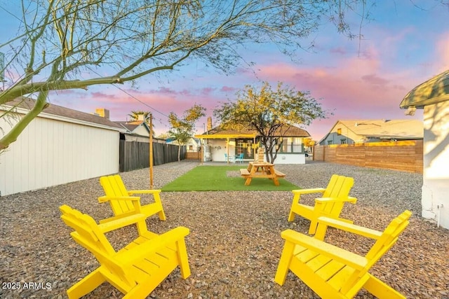 yard at dusk with a patio area