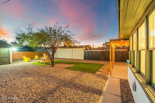 yard at dusk with a pergola