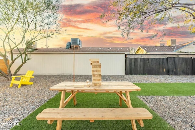 yard at dusk featuring central AC unit