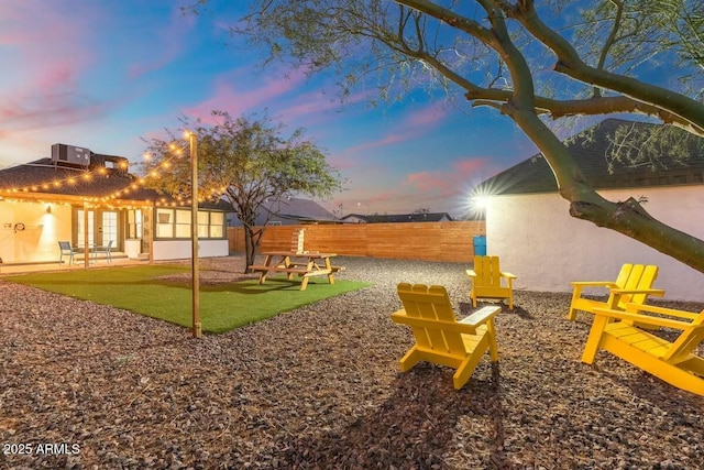 yard at dusk with a patio area