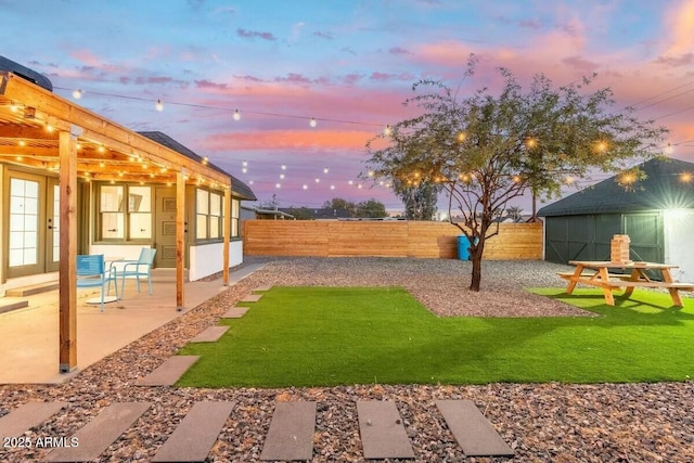 yard at dusk with a patio