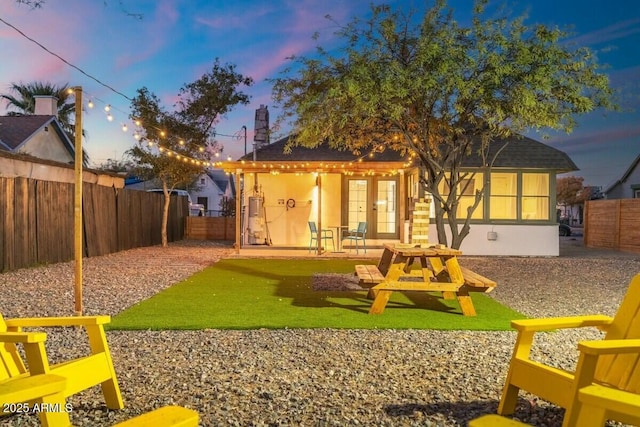 back house at dusk with french doors