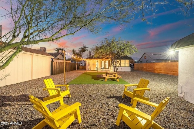 yard at dusk featuring a patio area