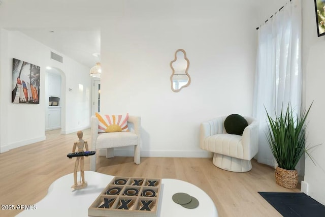 living area with hardwood / wood-style floors