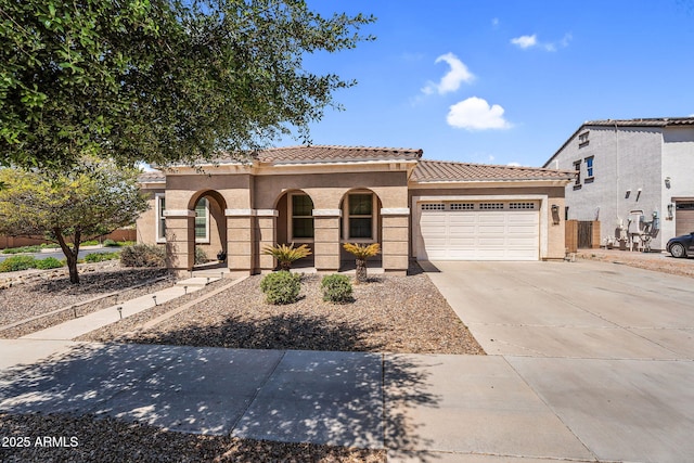 21004 E Sunset Dr, Queen Creek, AZ 85142 - mediterranean / spanish home featuring an attached garage, a tiled roof, concrete driveway, and stucco siding