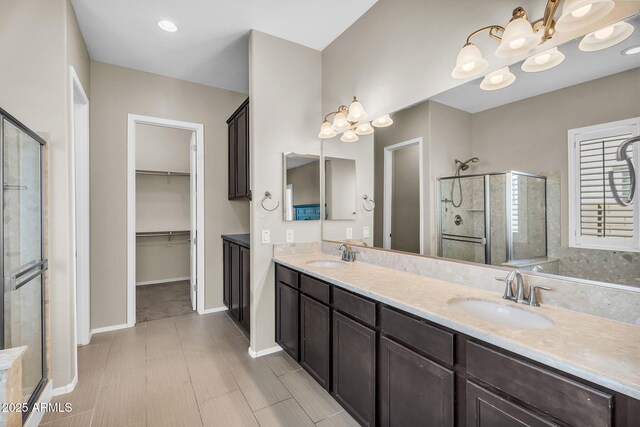 21004 E Sunset Dr, Queen Creek, AZ 85142 - full bathroom with a shower stall, double vanity, a notable chandelier, and a sink