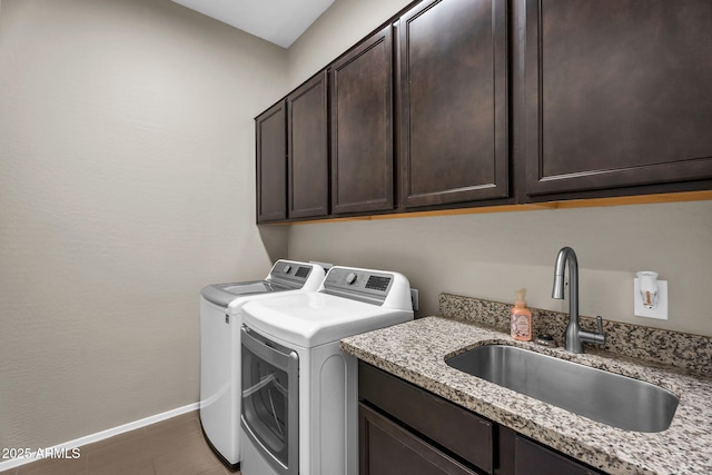 21004 E Sunset Dr, Queen Creek, AZ 85142 - laundry room featuring a sink, washer and clothes dryer, cabinet space, and baseboards