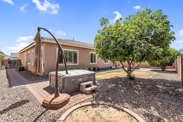 21004 E Sunset Dr, Queen Creek, AZ 85142 - back of property featuring a hot tub, cooling unit, stucco siding, fence private yard, and a patio area