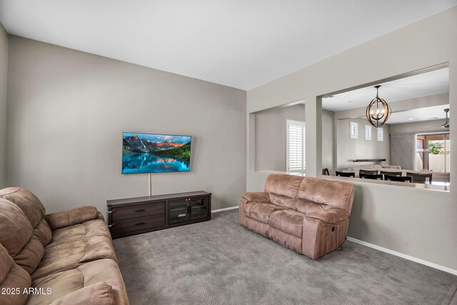 21004 E Sunset Dr, Queen Creek, AZ 85142 - carpeted living room with an inviting chandelier and baseboards