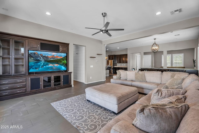 21004 E Sunset Dr, Queen Creek, AZ 85142 - living area with ceiling fan with notable chandelier, baseboards, visible vents, and recessed lighting