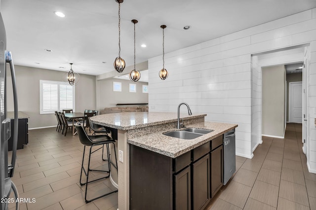 21004 E Sunset Dr, Queen Creek, AZ 85142 - kitchen with an island with sink, dark brown cabinets, appliances with stainless steel finishes, a sink, and baseboards