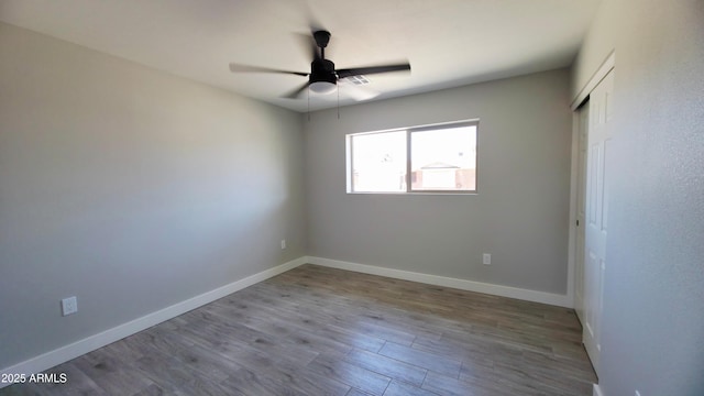 4219 W Citrus Way, Phoenix, AZ 85019 - unfurnished bedroom featuring wood finished floors, baseboards, a closet, and a ceiling fan