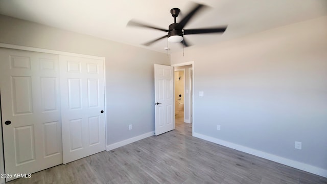 4219 W Citrus Way, Phoenix, AZ 85019 - unfurnished bedroom with wood finished floors, baseboards, a closet, and a ceiling fan