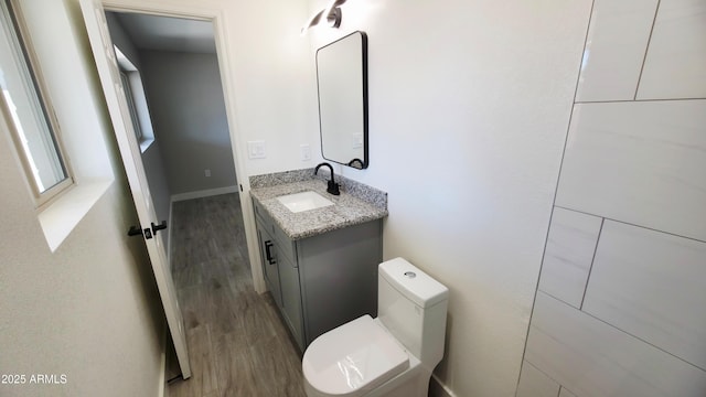 4219 W Citrus Way, Phoenix, AZ 85019 - half bath featuring wood finished floors, vanity, and toilet