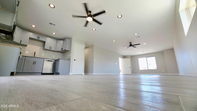 4219 W Citrus Way, Phoenix, AZ 85019 - unfurnished living room featuring ceiling fan, baseboards, recessed lighting, a sink, and light wood-style flooring