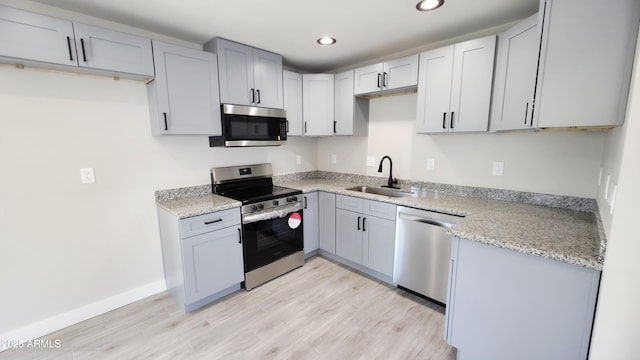 4219 W Citrus Way, Phoenix, AZ 85019 - kitchen with stainless steel appliances, a sink, recessed lighting, light wood finished floors, and gray cabinetry